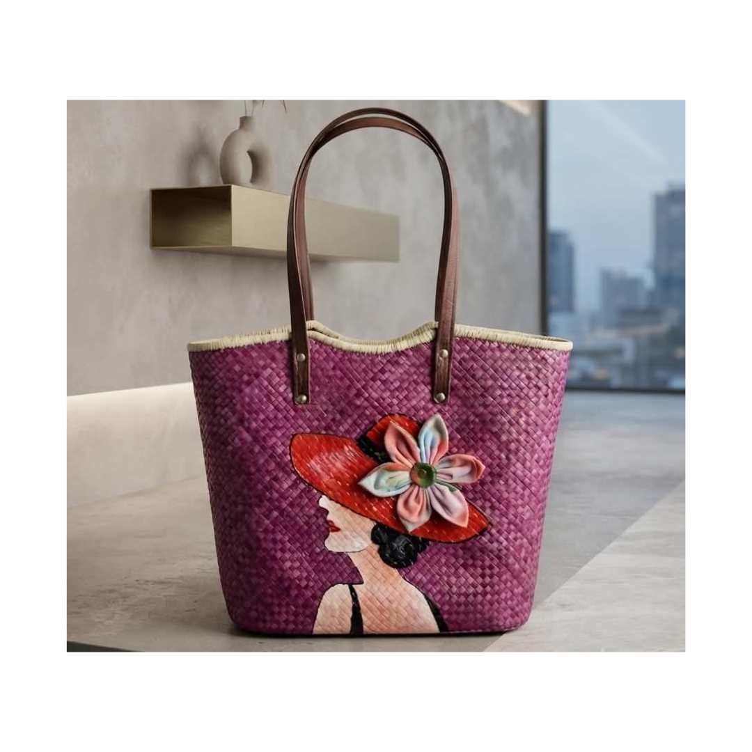 Hand-painted portrait bayong tote featuring a woman in a wide-brimmed hat with tropical flowers, set against a sunset palm scene