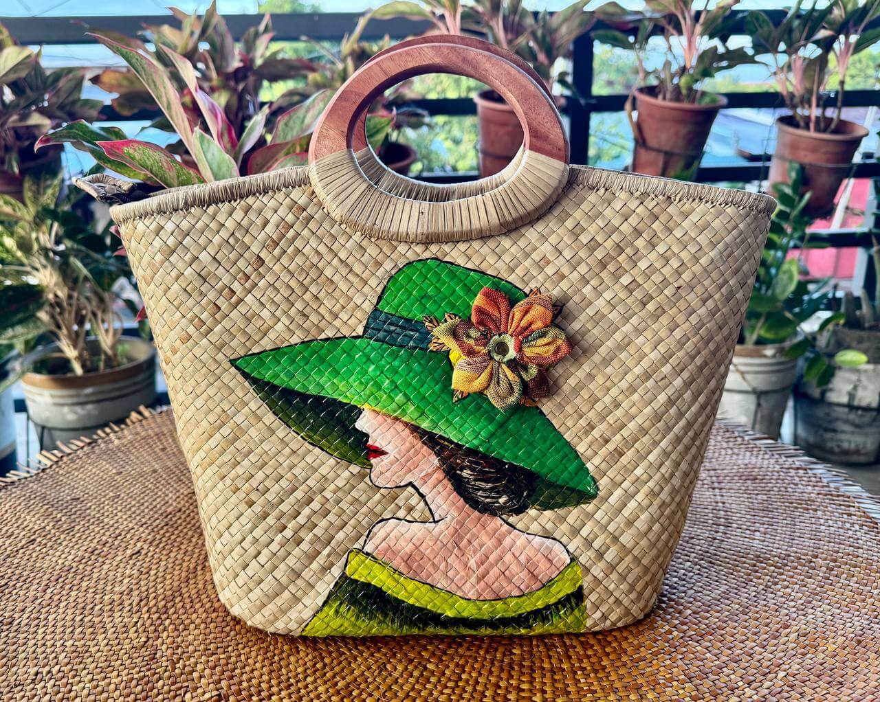 Hand-painted portrait tote featuring a woman in a green wide-brimmed sunhat with 3D floral accent