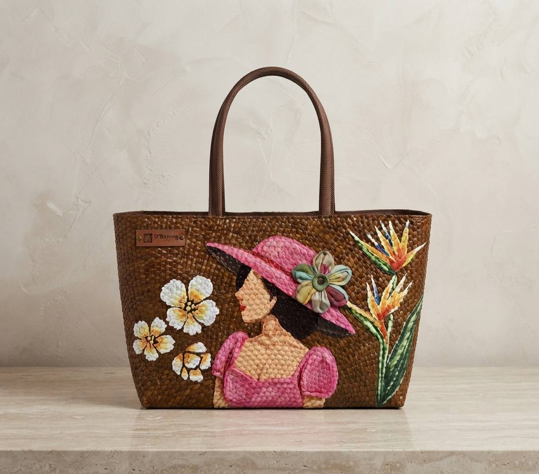 La Señorita hand-painted bayong tote, featuring a woman in a pink hat and bird of paradise flowers